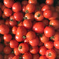 Dozens of small round red tomatoes.