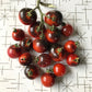 Red cherry tomatoes with anthocyanin shoulders.